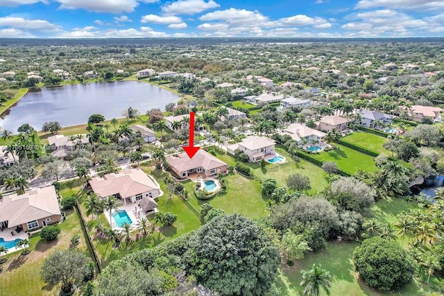 birds eye view of property with a water view