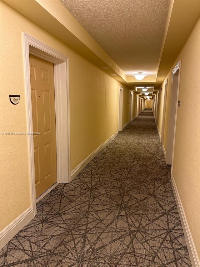 hallway featuring a textured ceiling