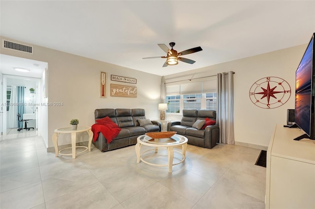 living room featuring light tile patterned floors and ceiling fan