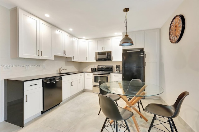 kitchen featuring black appliances, pendant lighting, white cabinetry, and sink