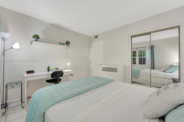 bedroom featuring light tile patterned flooring and a closet