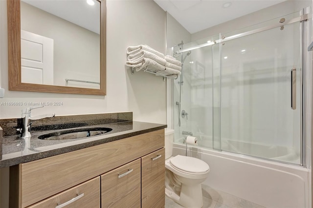 full bathroom with tile patterned floors, vanity, toilet, and combined bath / shower with glass door