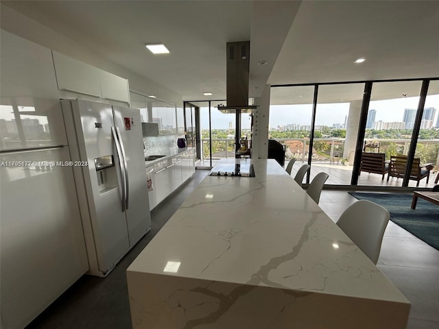 kitchen featuring white cabinetry, plenty of natural light, and a kitchen island