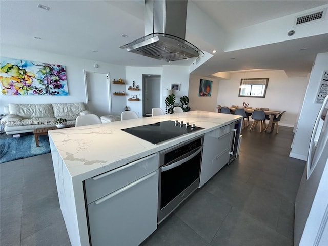 kitchen with stainless steel oven, black electric cooktop, island range hood, a center island, and fridge