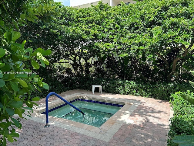 view of pool with an in ground hot tub