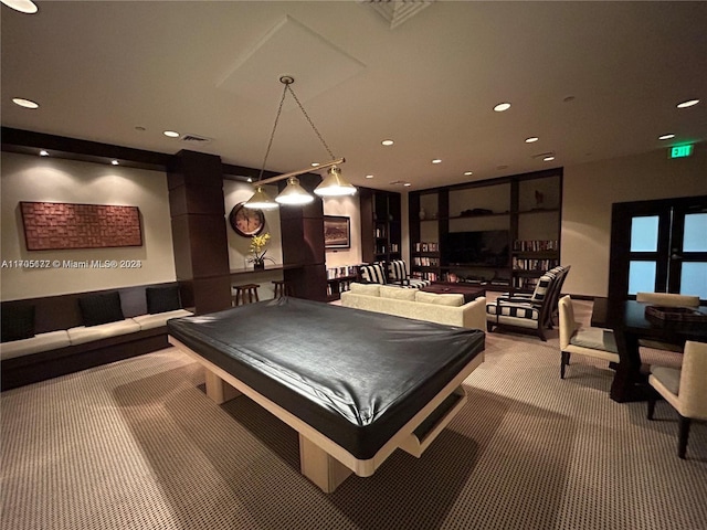 recreation room with light carpet and pool table