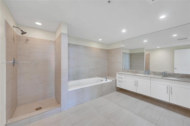 bathroom with tile patterned floors, vanity, and separate shower and tub