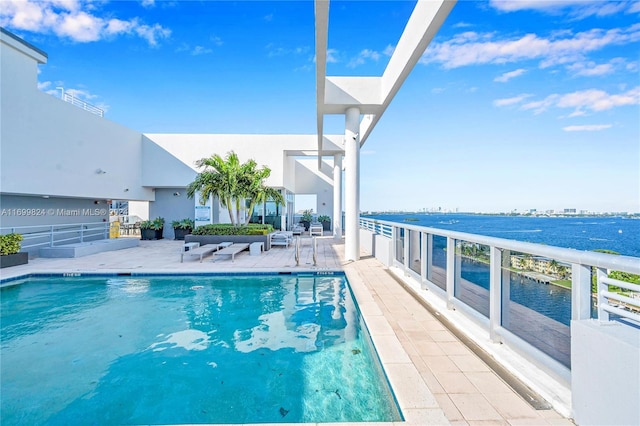 view of swimming pool with a water view