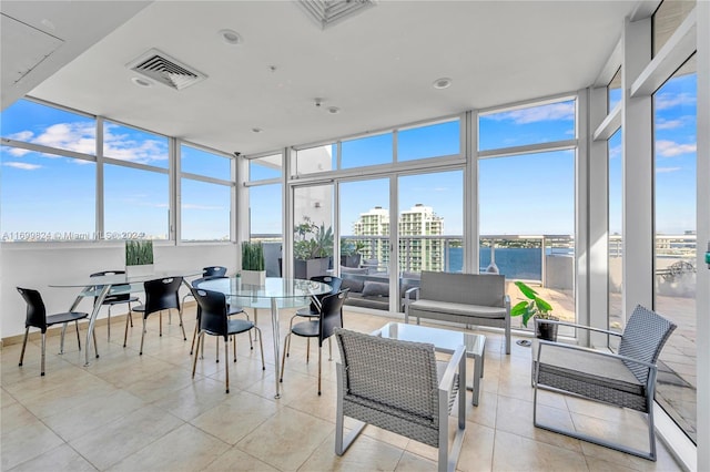 sunroom / solarium with a healthy amount of sunlight and a water view