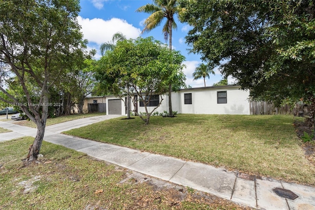 view of front facade with a garage and a front lawn