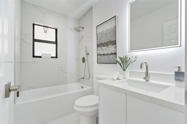 full bathroom featuring vanity, tiled shower / bath combo, and toilet