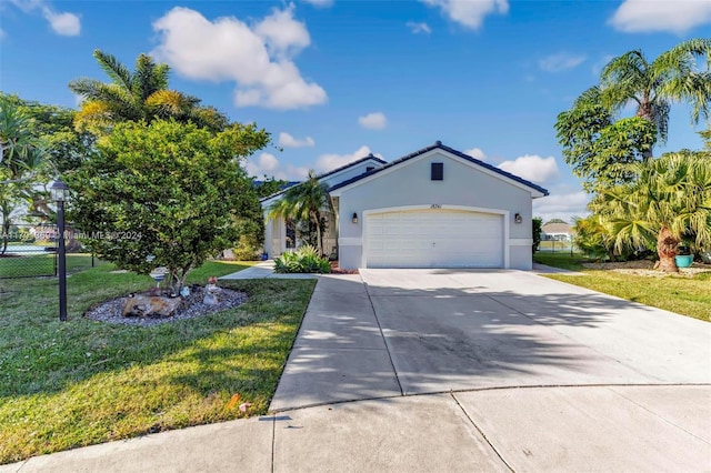 view of front of house with a front yard and a garage