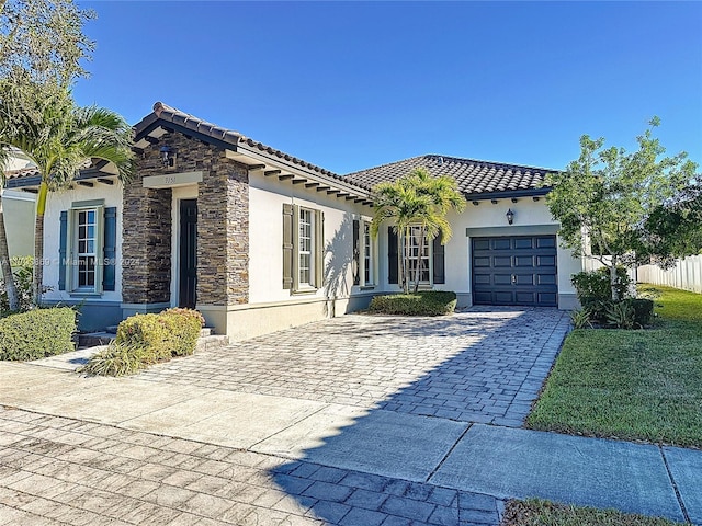 mediterranean / spanish-style home with a garage