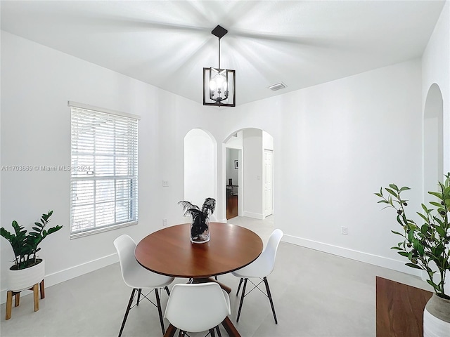 dining space with an inviting chandelier