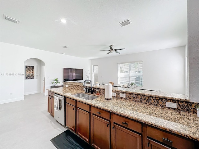 kitchen with dishwasher, light carpet, sink, ceiling fan, and light stone countertops