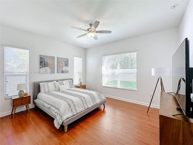 bedroom with hardwood / wood-style flooring and ceiling fan