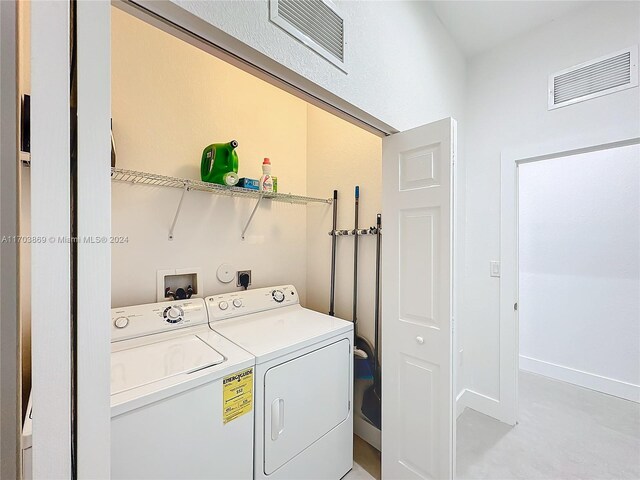 clothes washing area featuring washing machine and dryer