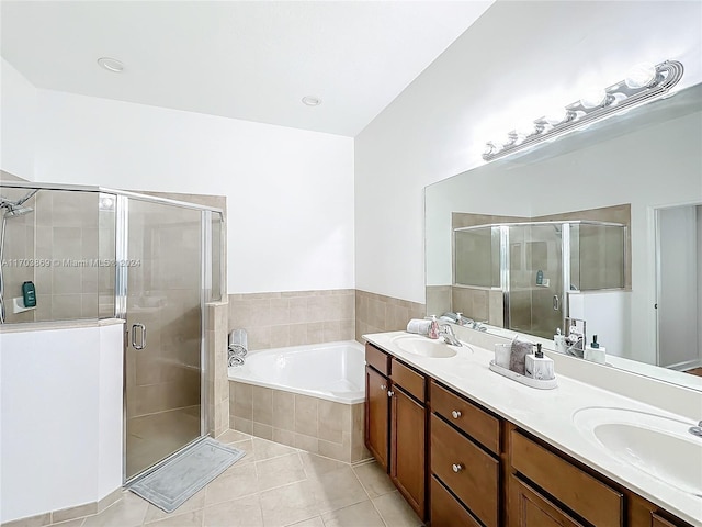 bathroom with tile patterned flooring, shower with separate bathtub, and vanity