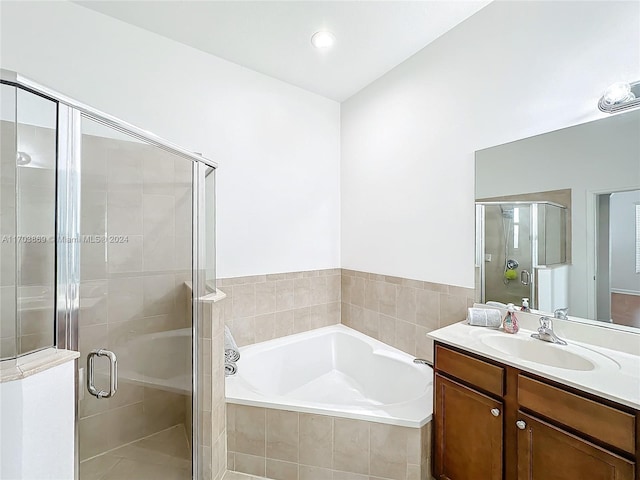 bathroom with vanity and independent shower and bath