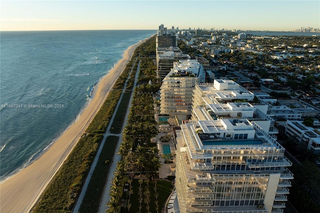 birds eye view of property featuring a water view and a view of the beach