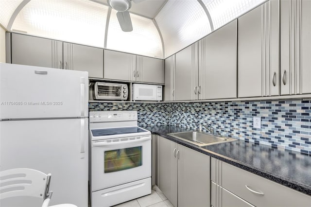 3029 Berkshire B 3029, Deerfield Beach, FL 33442 - kitchen with a sink, dark countertops, decorative backsplash, white appliances, and gray cabinets