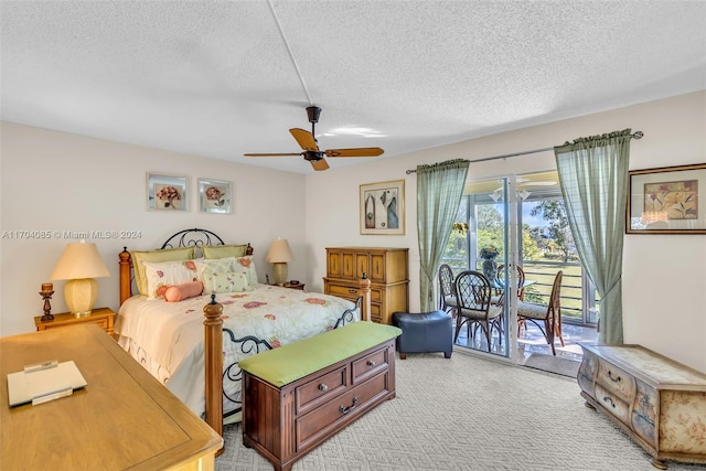 carpeted bedroom featuring access to exterior, ceiling fan, and a textured ceiling