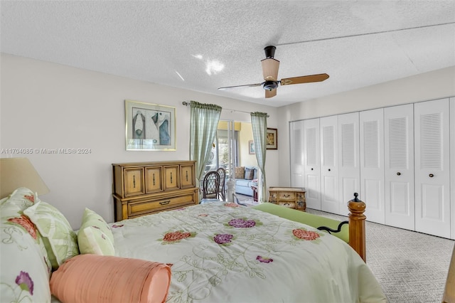 bedroom with ceiling fan, a closet, carpet, and a textured ceiling