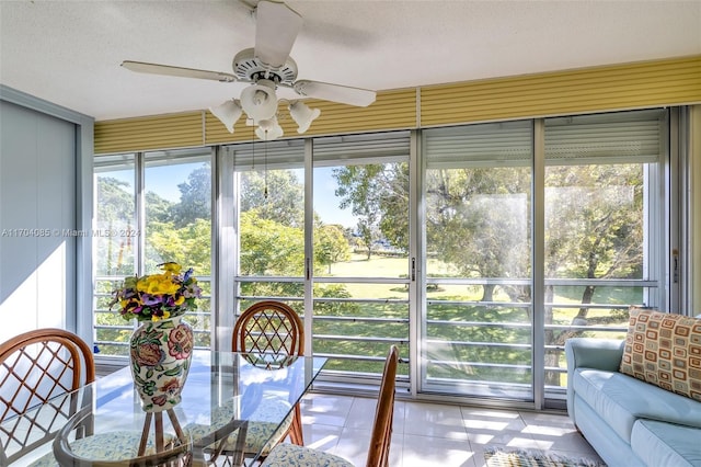 sunroom / solarium featuring ceiling fan and plenty of natural light