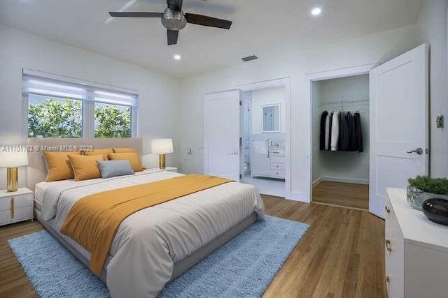 bedroom featuring connected bathroom, dark hardwood / wood-style floors, and ceiling fan