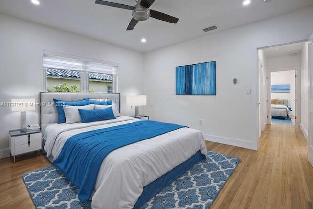 bedroom with hardwood / wood-style flooring and ceiling fan