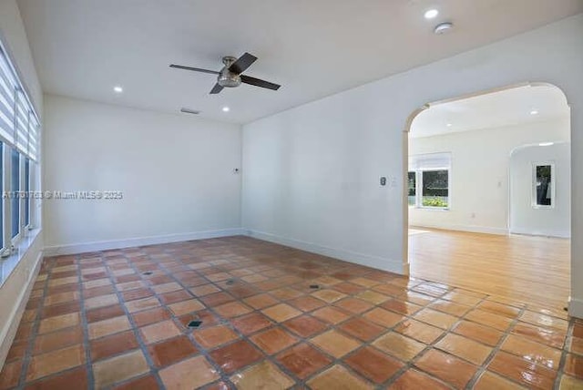 empty room featuring tile patterned floors and ceiling fan