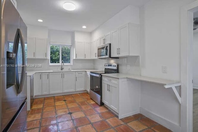 kitchen with white cabinetry, sink, appliances with stainless steel finishes, and tasteful backsplash