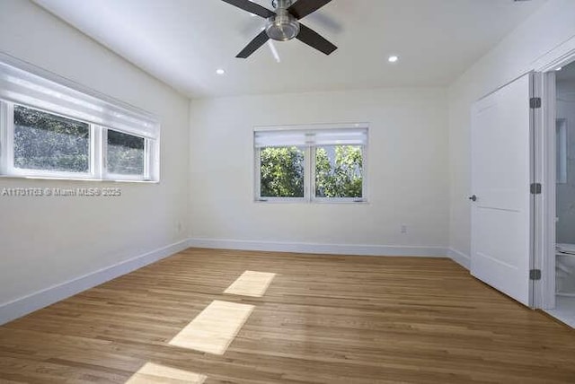 unfurnished room with hardwood / wood-style flooring and ceiling fan