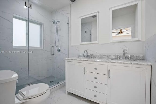 bathroom with vanity, toilet, and a shower with shower door