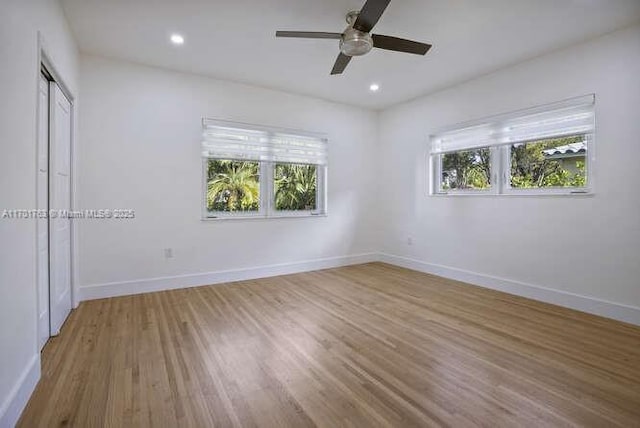 unfurnished bedroom featuring hardwood / wood-style floors and ceiling fan