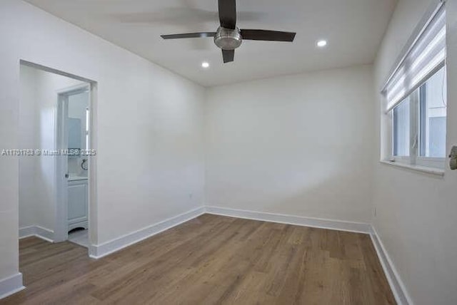 spare room featuring hardwood / wood-style floors and ceiling fan