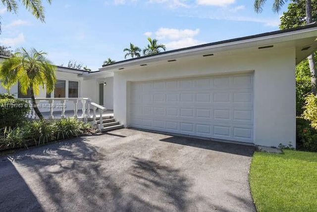 exterior space featuring covered porch and a garage