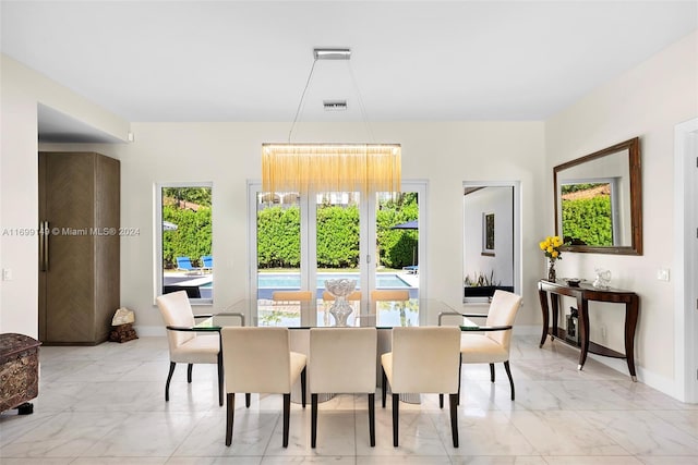 511 Madeira Ave, Coral Gables, FL 33134 - dining area featuring light marble finish flooring and baseboards