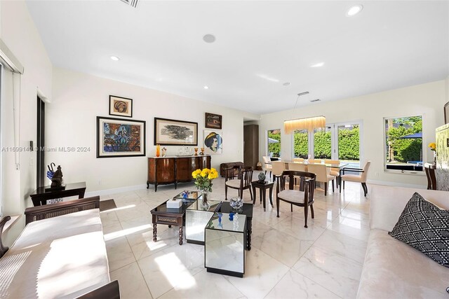 511 Madeira Ave, Coral Gables, FL 33134 - living room with recessed lighting, baseboards, and light marble finish floors