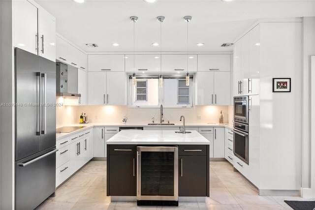 511 Madeira Ave, Coral Gables, FL 33134 - kitchen with wine cooler, stainless steel appliances, modern cabinets, a sink, and recessed lighting