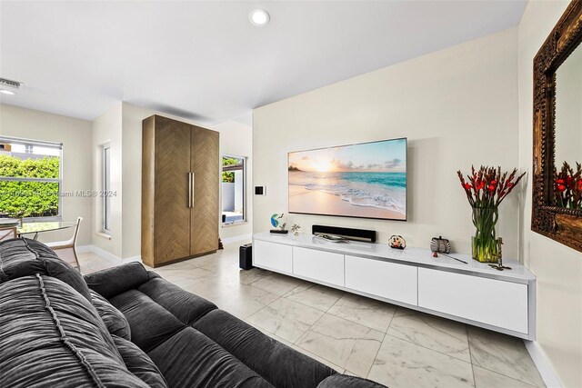 511 Madeira Ave, Coral Gables, FL 33134 - living room with light marble finish floors, baseboards, and recessed lighting