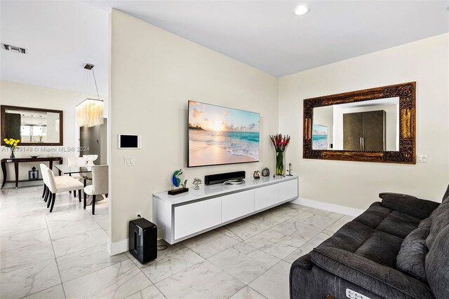 511 Madeira Ave, Coral Gables, FL 33134 - living room with light marble finish flooring, baseboards, and recessed lighting