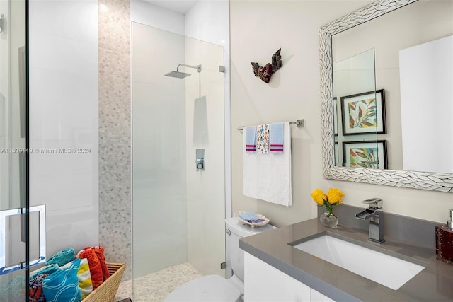 bathroom featuring vanity, toilet, and walk in shower