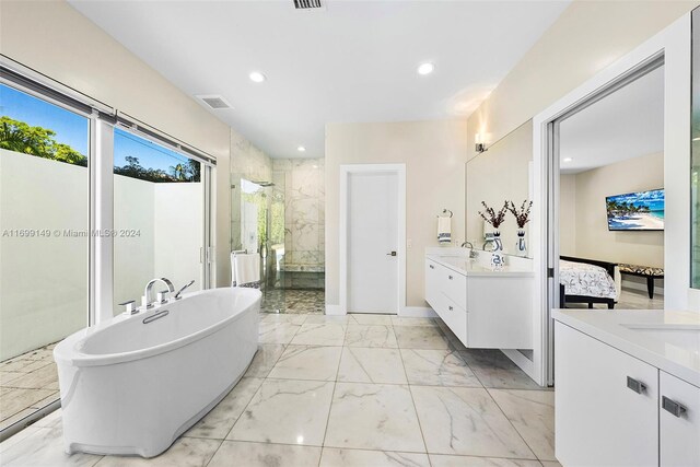 511 Madeira Ave, Coral Gables, FL 33134 - full bath with two vanities, a shower stall, marble finish floors, a soaking tub, and recessed lighting