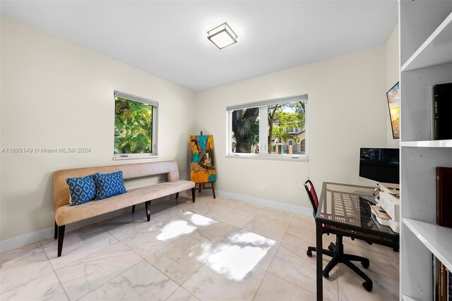 511 Madeira Ave, Coral Gables, FL 33134 - office space featuring healthy amount of natural light, marble look tile flooring, and baseboards
