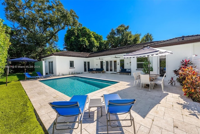 view of swimming pool featuring ceiling fan and a patio area