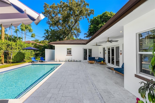 view of pool with french doors, a patio, and ceiling fan