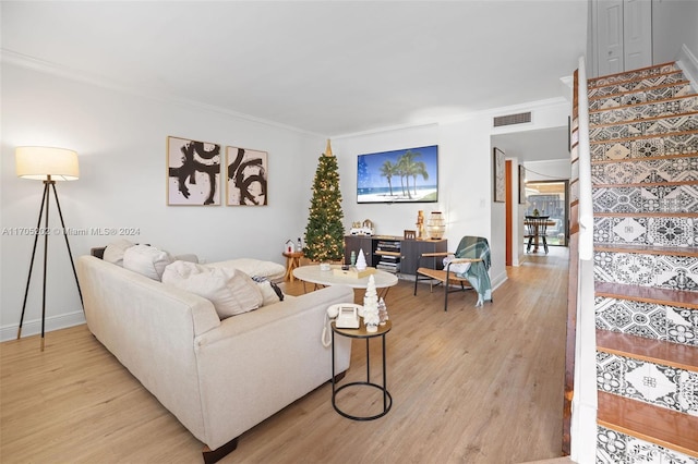 living room with light hardwood / wood-style floors and ornamental molding