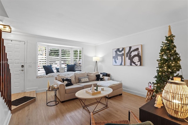 living room featuring light hardwood / wood-style flooring and ornamental molding