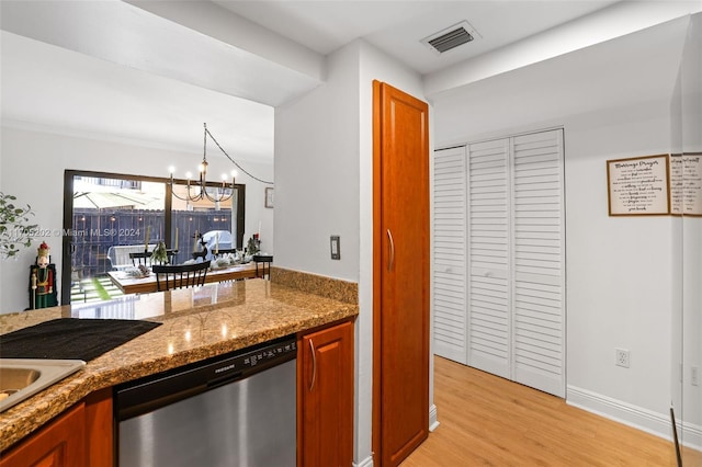 kitchen featuring stone counters, light hardwood / wood-style floors, stainless steel dishwasher, and a notable chandelier